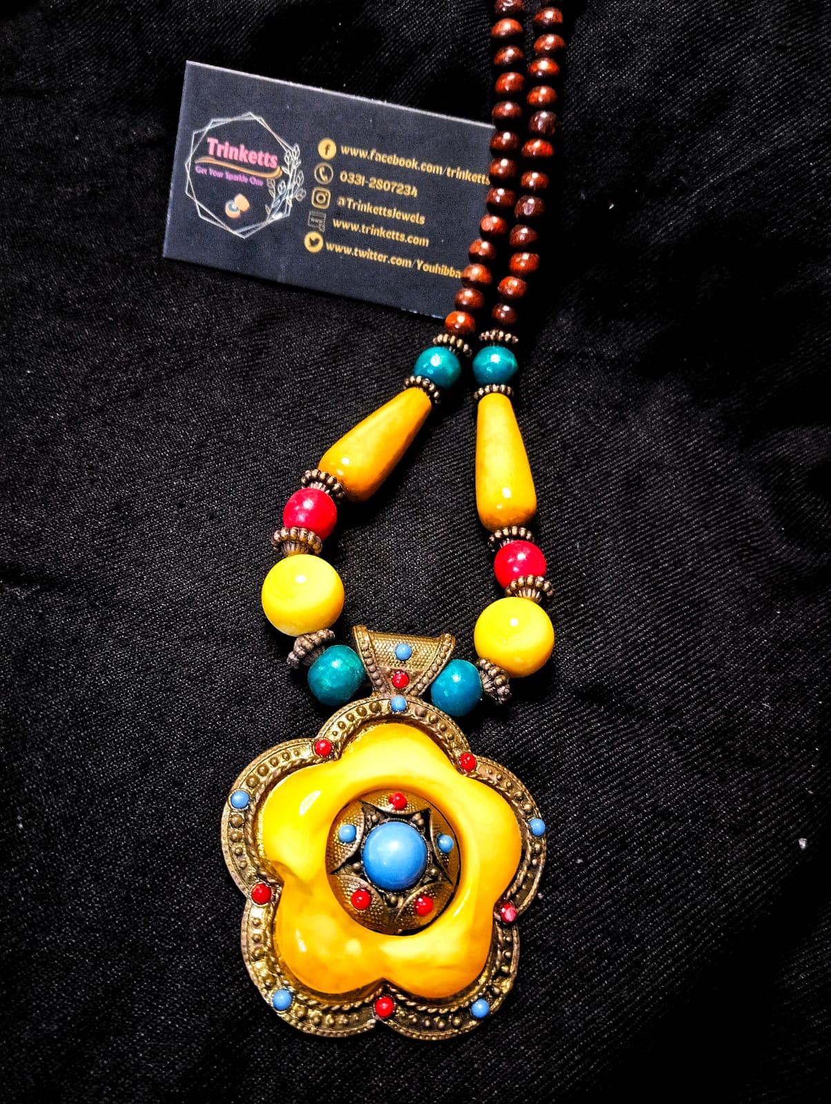 Discover timeless beauty in our Antique-Style Floral Maala. Vibrant yellow and blue hues, accented with delicate red, exude vintage charm. Elevate your style effortlessly with this exquisite piece.