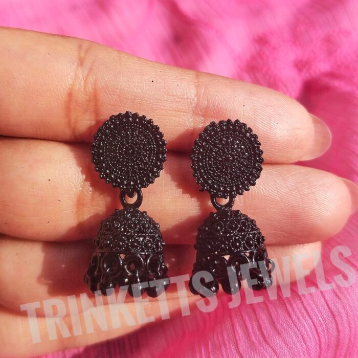 Black metal Jhumki earrings, approximately 1.5 inches in size. The design features an intricate circular pattern with a hanging Jhumki plate adorned with white beads. Elegant and timeless, these Jhumkis add a touch of Indian charm to your style