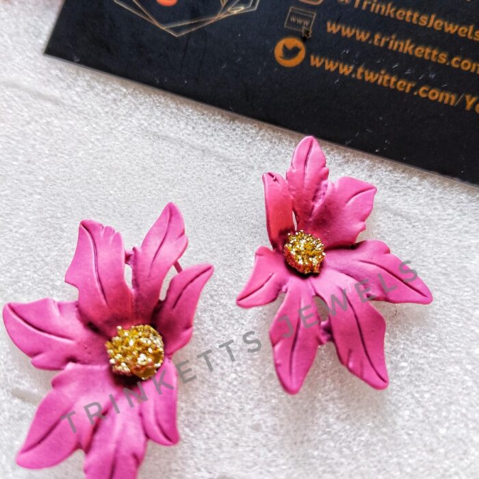 Handcrafted pink clay floral studs with leafy petals and a center rhinestone in copper. Artisanal jewelry, blending nature-inspired design with the warmth of clay craftsmanship.