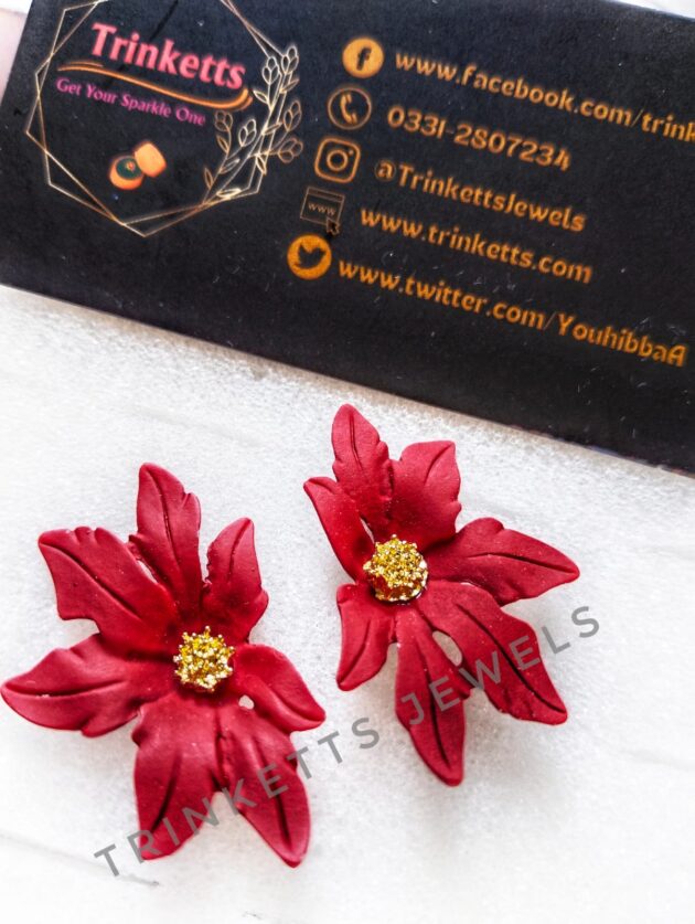 Handcrafted red clay floral studs with leafy petals and a center rhinestone in copper. Artisanal jewelry, blending nature-inspired design with the warmth of clay craftsmanship.