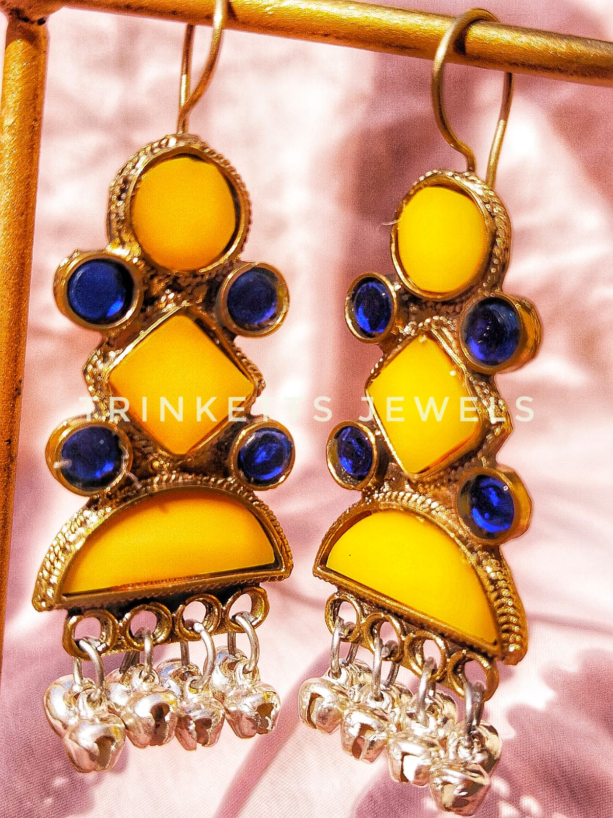 Elegant Afghani earrings featuring yellow matte stones in circle, diamond, and semi-circle shapes, adorned with blue crystal accents and a row of ghungroos in a semi-circle. Available in dazzling golden polish.