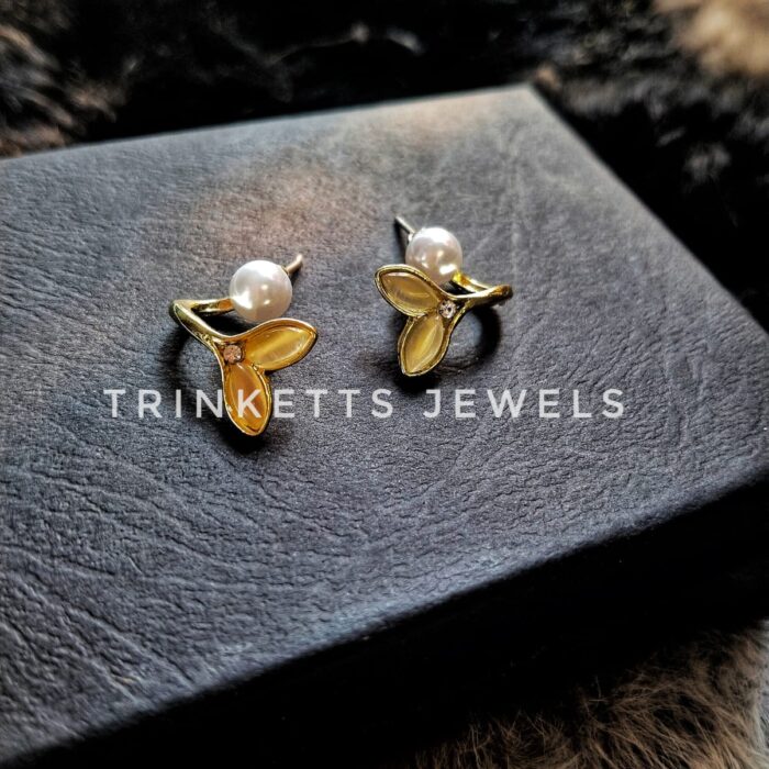 Trinketts Golden Fish Tail Front Back Earrings: 925 Silver with Anti-Tarnish Finish, White Pearl Accent, Overlapping Design. Size: Less than half inch. Price: Rs. 350.